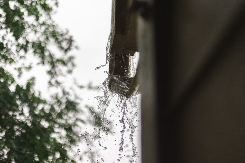 Close-up of rainwater pouring from a gutter during a rainfall