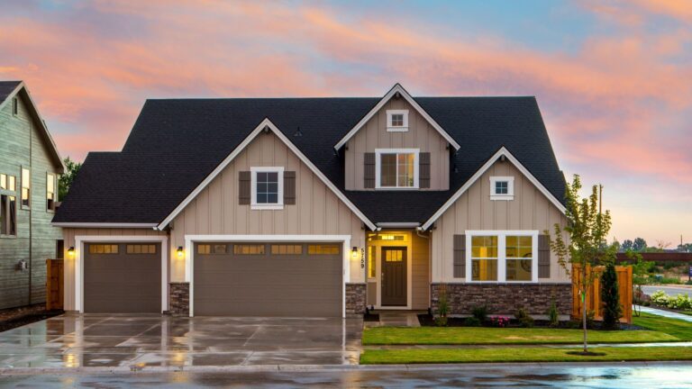 Suburban house with beige horizontal vinyl siding at dusk