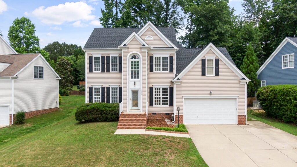 Two-story house with horizontal vinyl siding and a driveway